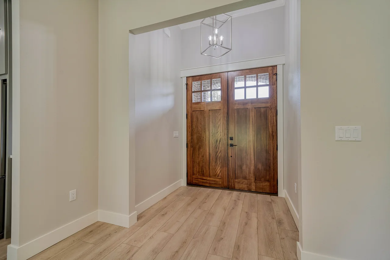 Front entry with double wood doors, Homes by Noble